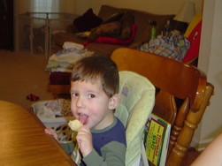 Caden licking a scoop chip